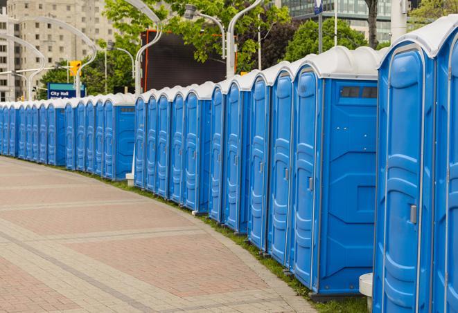 hygienic portable restrooms lined up at a beach party, ensuring guests have access to the necessary facilities while enjoying the sun and sand in Alto MI